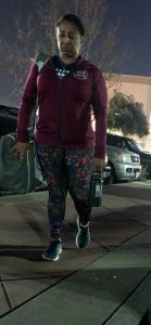 Photo of stoic looking woman walking in workout attire. Redefine Fitness to break the cycle of injury.